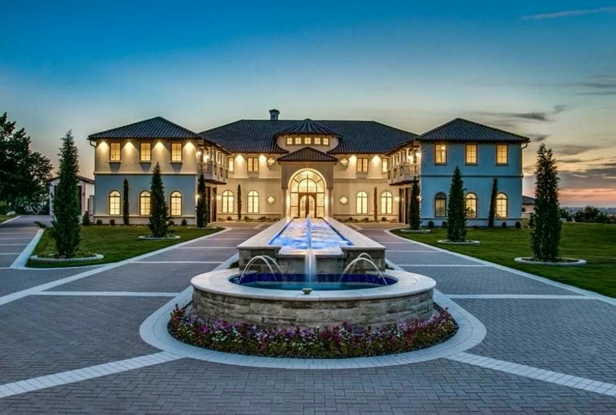 King Pools custom estate fountain and outdoor water feature at dusk