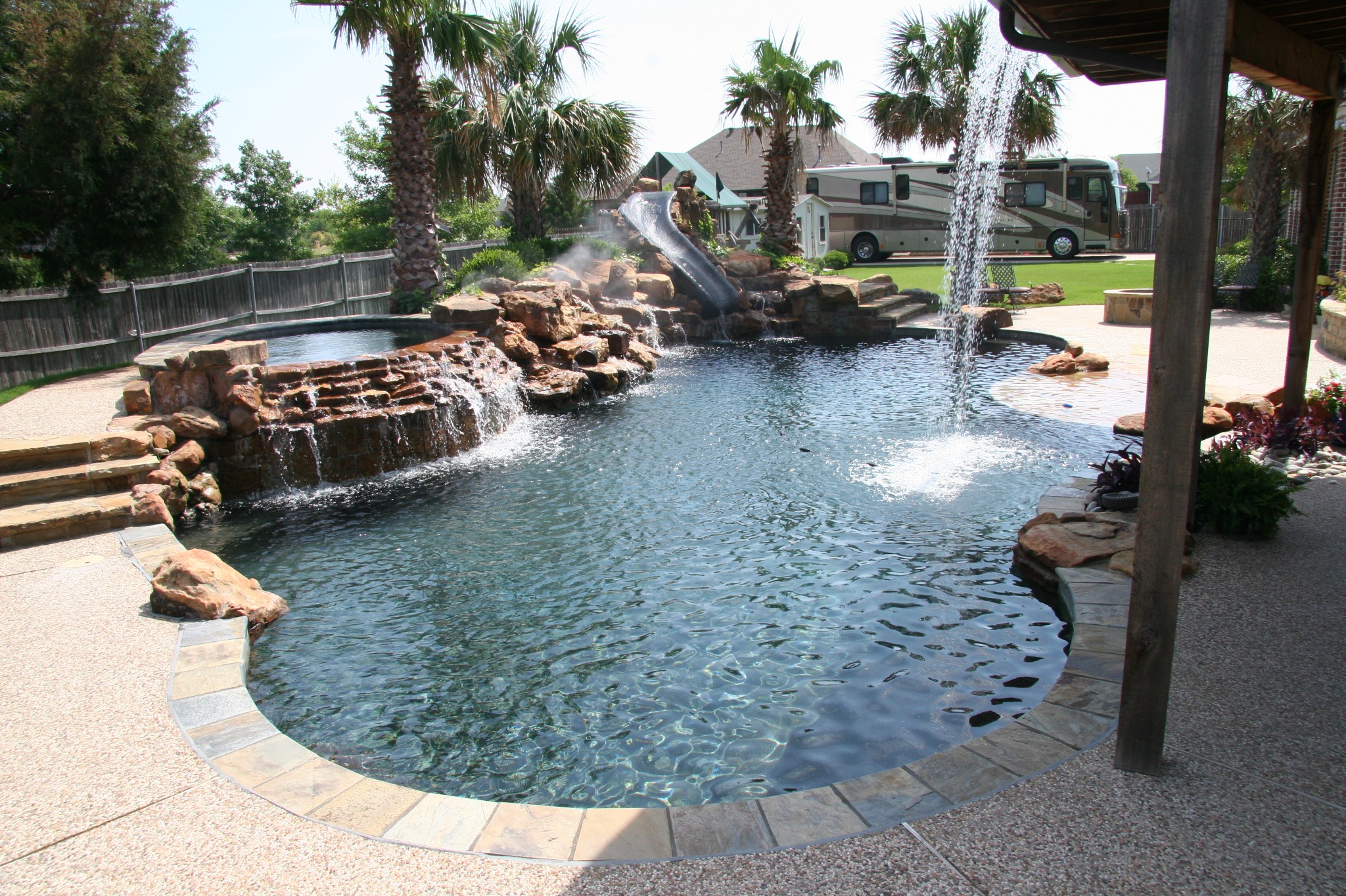 King Pools custom rock waterfall, waterslide, and swimming pool