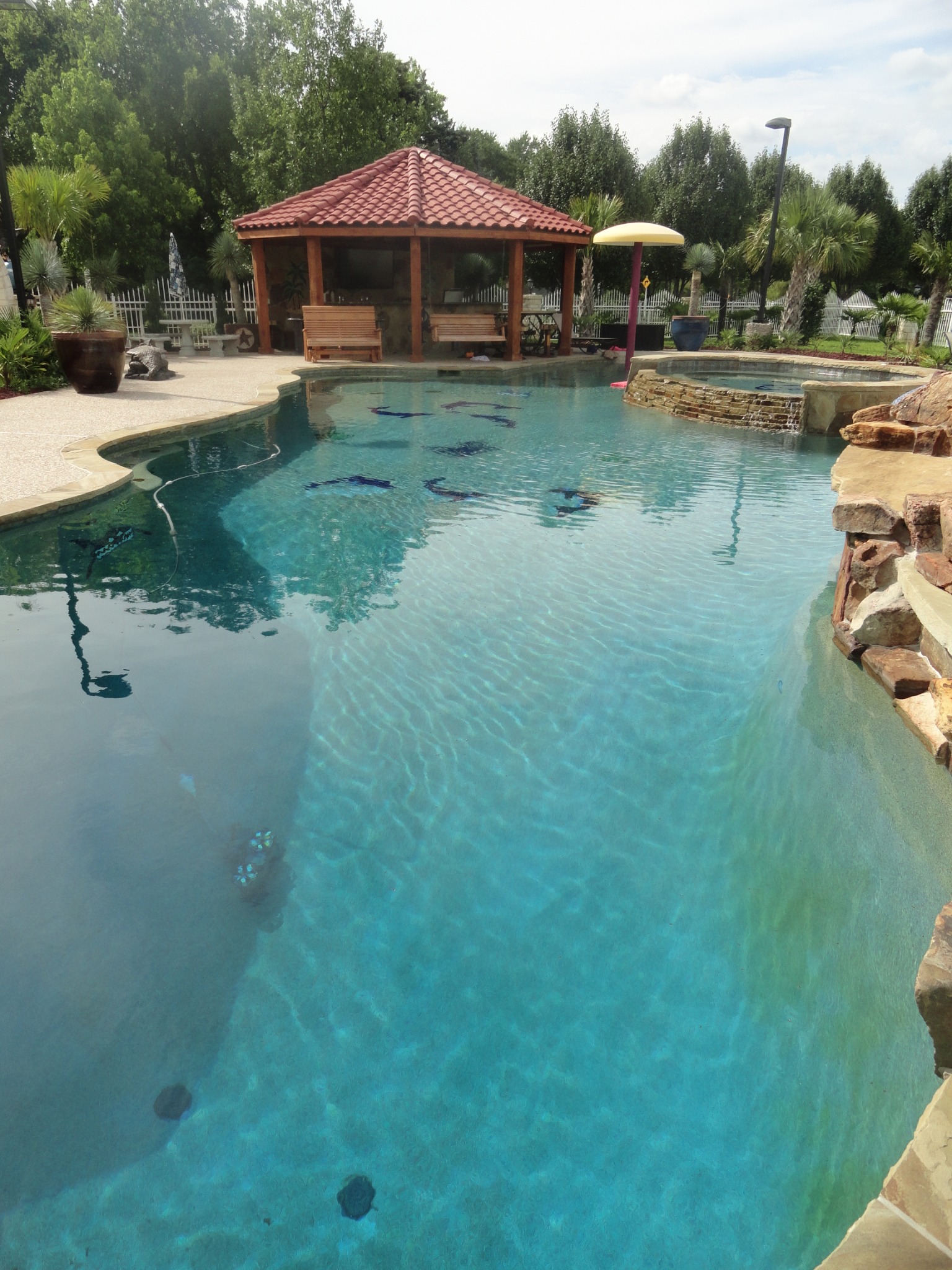 King Pools custom pool and outdoor living project with detailed stonework