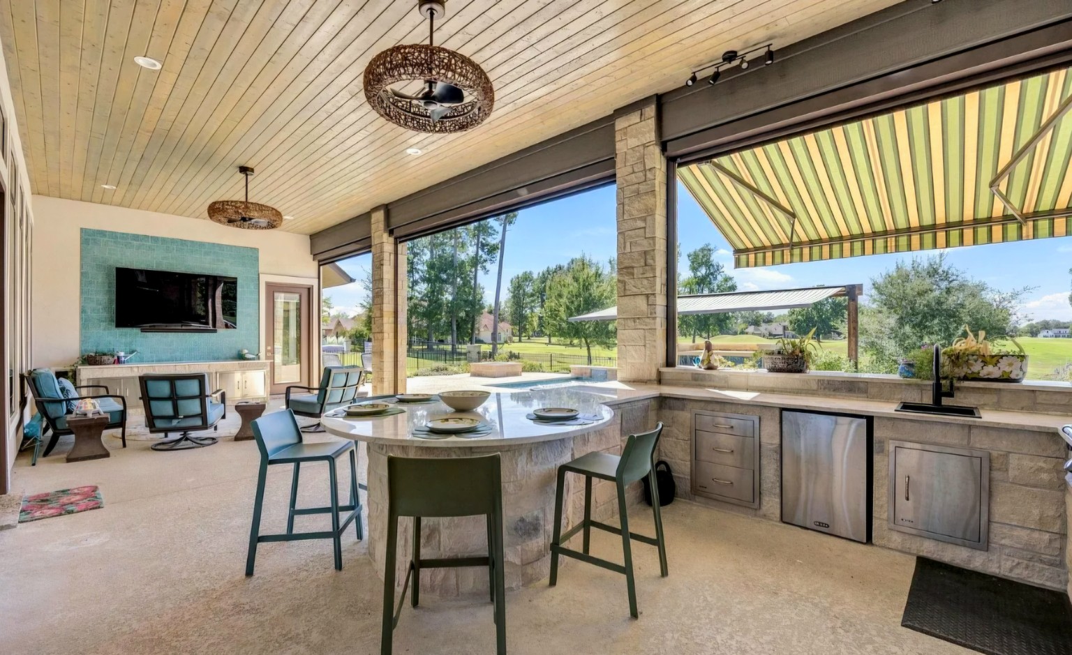 A wider kitchen view shows the relationship between cooking, dining, and the adjoining lounge area.