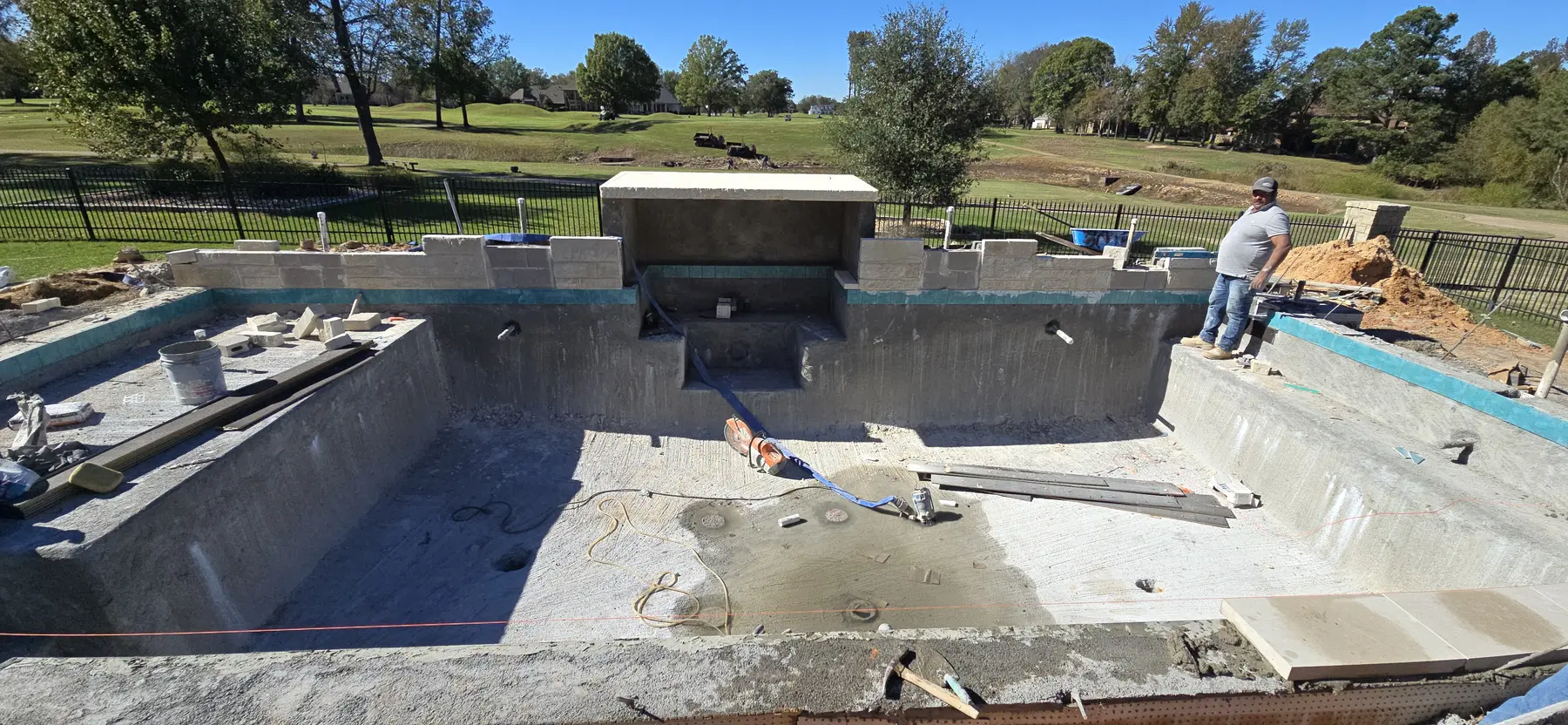 Raised water-feature wall built into the new pool shell